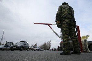 A member of the armed forces of the separatist self-proclaimed Donetsk People's Republic guards a border crossing point outside Uspenka
