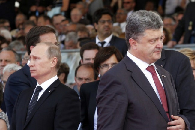 epa04242873 Ukraine's President-elect Petro Poroshenko (R), walks past Russian President Vladimir Putin during the commemoration of the 70th anniversary of the D-Day in Ouistreham, France, 06 June 2014. More than 75,000 British Canadian and other Commonwealth Troops Landed on the beaches of Normandy on 06 June 1944 alongside the United States and the Free French, in an Allied invasion of more than 130,000. Another 7,900 British troops were landed by Air.The invasion established a crucial second front in the Liberation of Europe from Nazi occupation, ultimately leading to victory for Allied Forces in 1945.  EPA/CHRISTOPHE ENA / POOL MAXPPP OUT